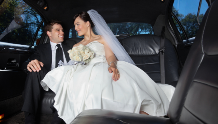 bride and groom in a limo 