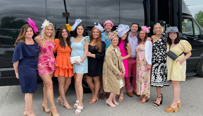 girls standing in from of party bus in kentucky derby attire